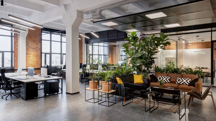 modern loft office interior with panoramic windows and a row of dark wood tables